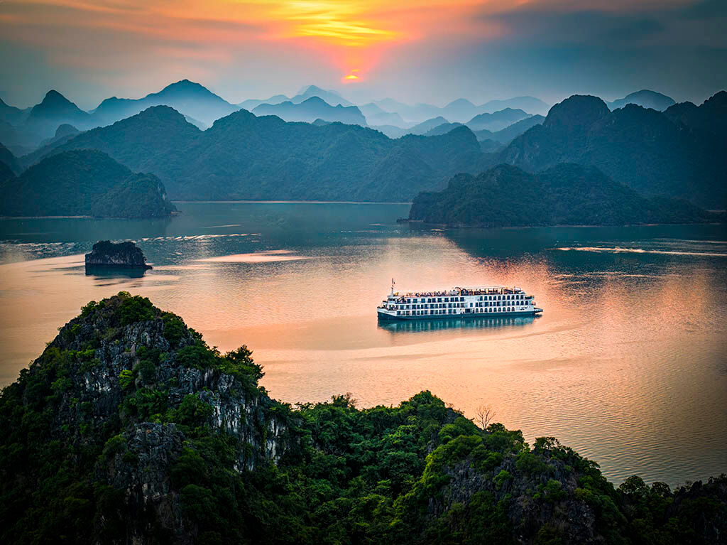 Experience serenity as you sail through Halong Bay’s limestone wonders
